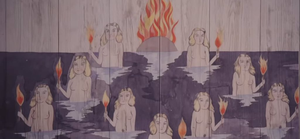 mais uma ilustração sobre a madeira. mulheres estão representadas dentro da água, segurando tochas. ao fundo, uma bola está pegando fogo (provavelmente, representando o por do sol)