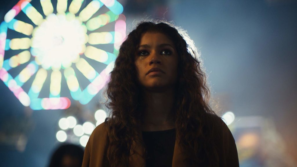 Rue, durante a feira da cidade, parada em frente a roda gigante. Euphoria. Maratona de Sofá.