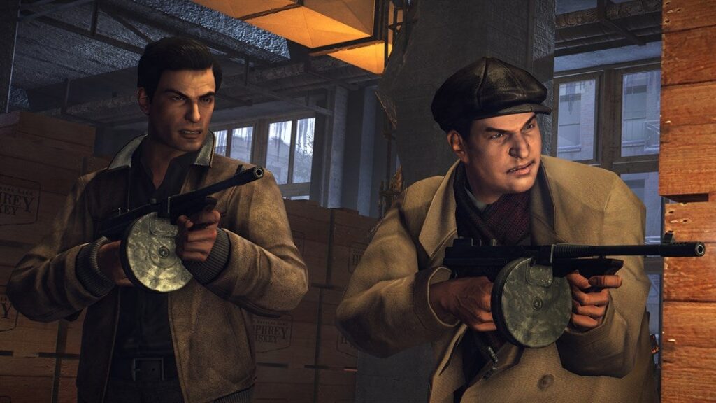 Vito e Joe atirando em inimigos em um armazem