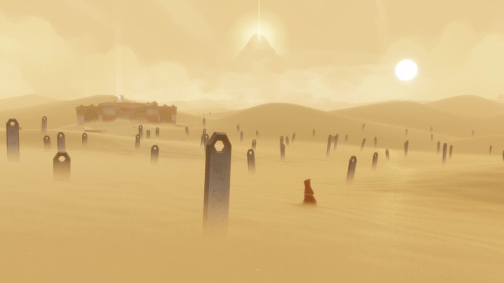 O viajante sentado no deserto, envolto de lapides, com a montanha ao fundo em Journey