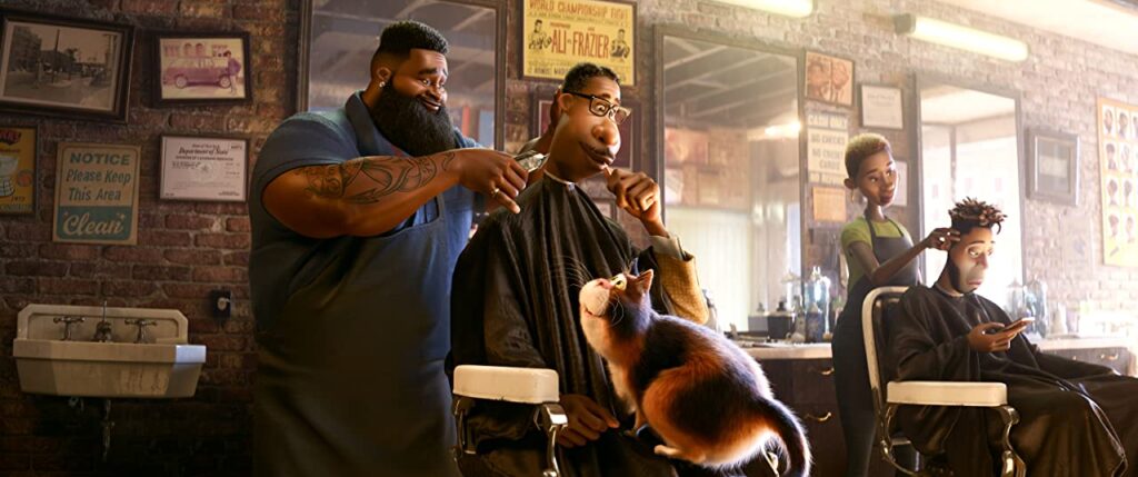 Cena no Barbeiro. Dez está cortando o cabelo de Joe, que está com um pirulito na boca (e parece estar se divertindo com isso), e tem um gato sobre seu colo. Do lado, Paul (Daveed Deegs) está recebendo um corte de cabelo feito por uma funcionária do local.