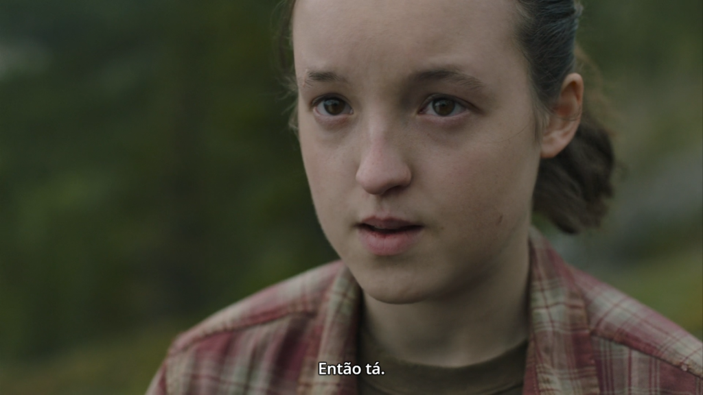 Cena de The Last of Us. Ellie, em close, olha (de baixo para cima) para Joel (fora do quadro) e diz "Então Tá"